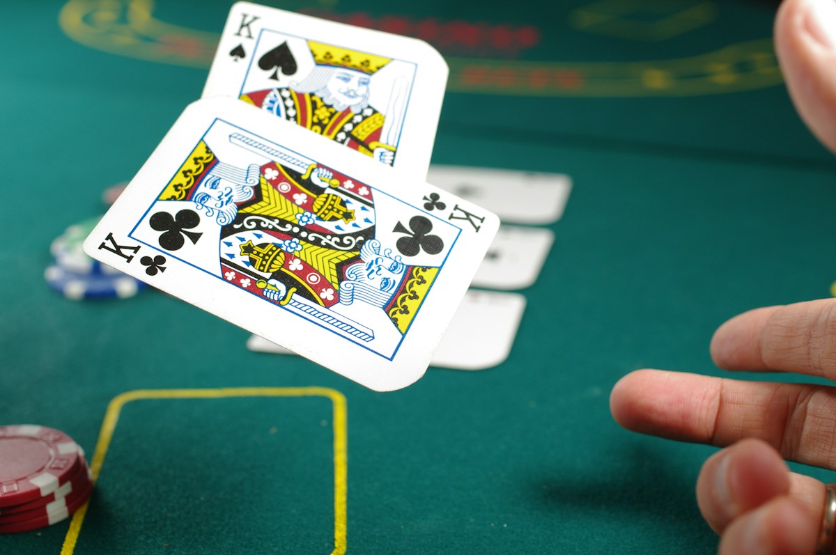 Playing cards and casino chips above a green gaming table